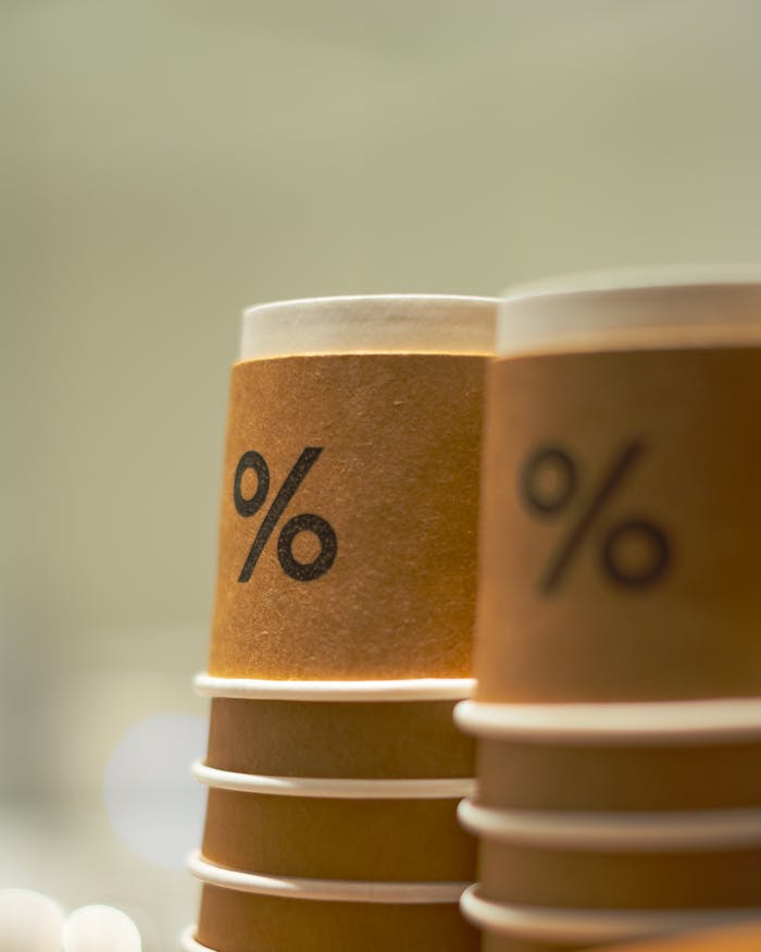 Close-up of stacked brown paper coffee cups featuring a percent sign design, ideal for coffee themes.